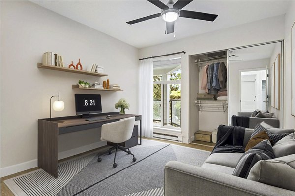 Cozy living room with home office setup at Lakeview at Newcastle Apartments, ideal for remote work and comfort