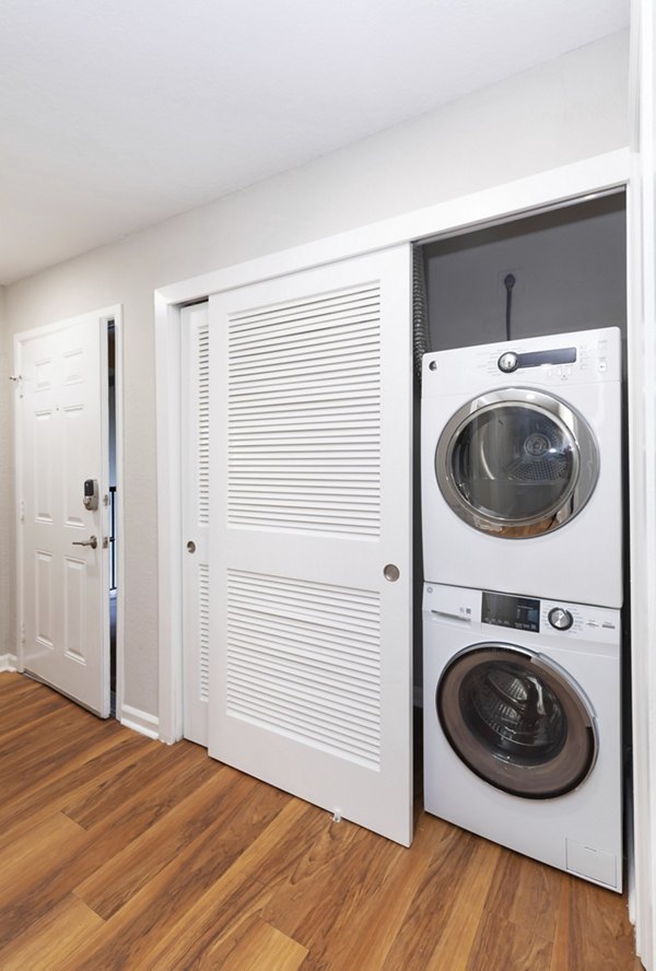 Laundry room with modern appliances at Cedar Rim Apartments