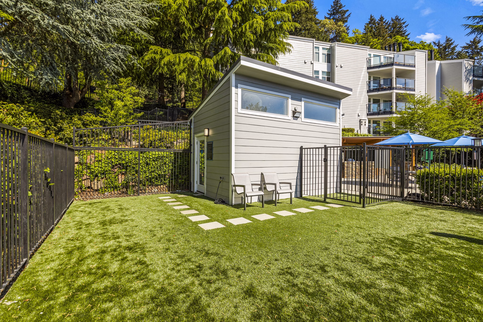 Inviting pool entrance at Lakeview at Newcastle Apartments featuring modern landscaping and seating areas