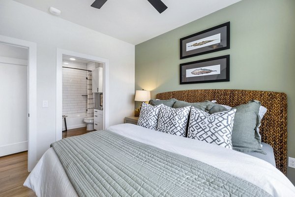 Bedroom with modern decor and large windows in Elan Harvest Green Apartments, luxury living by Greystar in a vibrant community