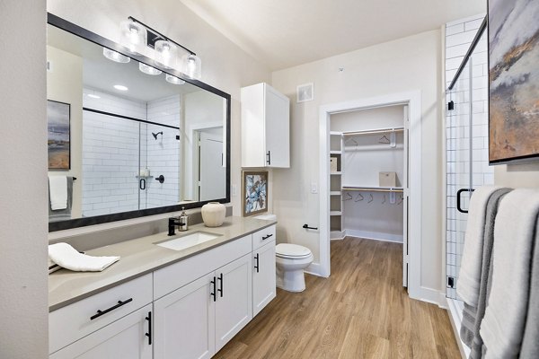 Luxurious bathroom with modern fixtures at Elan Harvest Green Apartments