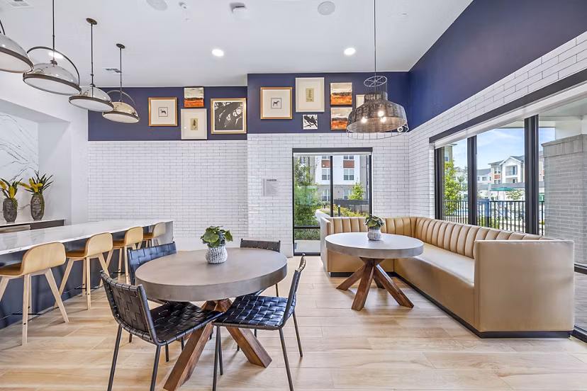 Clubhouse lobby area featuring modern furnishings and vibrant decor at Elan Harvest Green Apartments, offering a welcoming community space