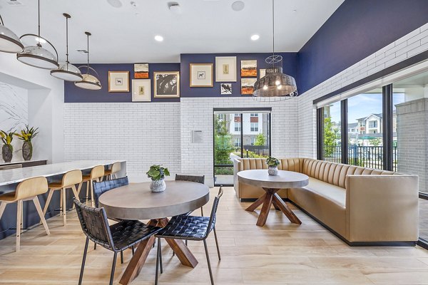 Clubhouse lobby area featuring modern furnishings and vibrant decor at Elan Harvest Green Apartments, offering a welcoming community space