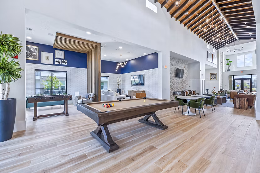 Modern clubhouse lobby with stylish seating at Elan Harvest Green Apartments, offering luxury living spaces for relaxation and socializing