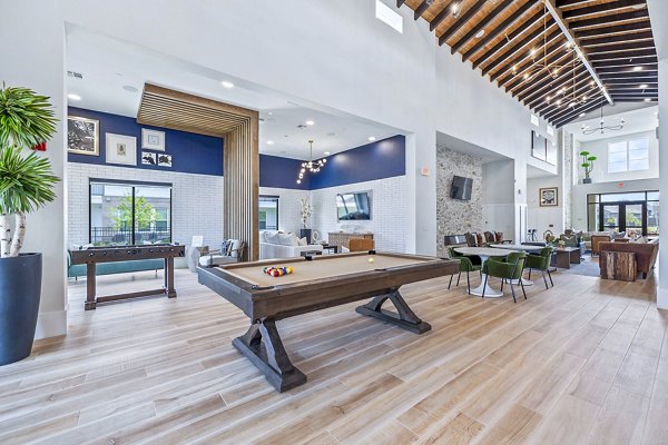 Modern clubhouse lobby with stylish seating at Elan Harvest Green Apartments, offering luxury living spaces for relaxation and socializing