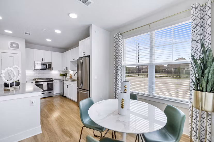 Dining room with modern decor and large windows at Elan Harvest Green Apartments