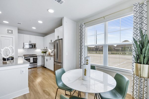 Dining room with modern decor and large windows at Elan Harvest Green Apartments