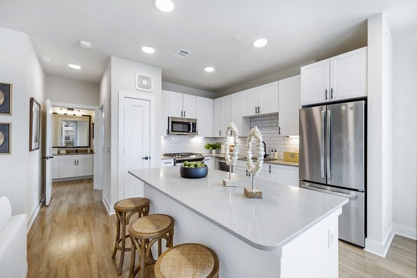 Modern kitchen with stainless steel appliances at Elan Harvest Green Apartments