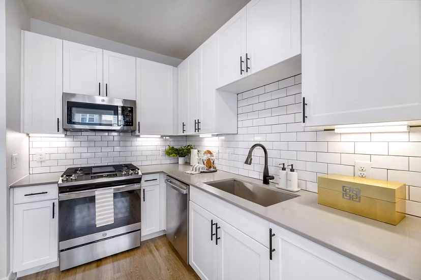 Contemporary kitchen featuring granite countertops and stainless steel appliances in Elan Harvest Green Apartments