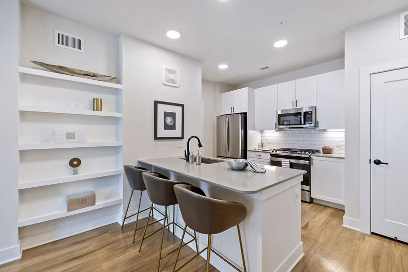 Kitchens with sleek stainless steel appliances and granite countertops at Elan Harvest Green Apartments