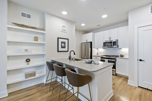 Kitchens with sleek stainless steel appliances and granite countertops at Elan Harvest Green Apartments