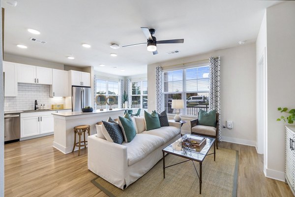 Living room featuring modern design and ample natural light at Elan Harvest Green Apartments