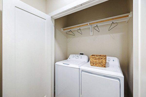Spacious laundry room with modern appliances at Elan Harvest Green Apartments