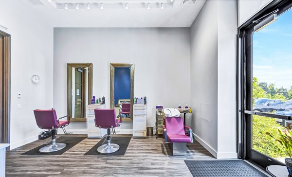 Clubhouse hair salon at Avenu at Natick Apartments featuring modern styling stations and luxurious amenities