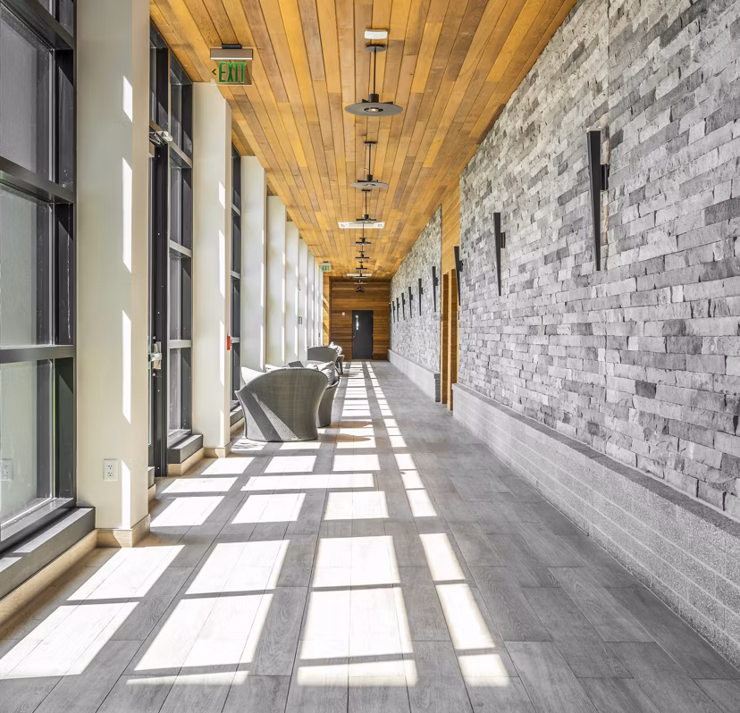 Clubhouse hallway with modern decor and lighting at Avenu at Natick Apartments