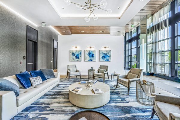 Clubhouse featuring modern design and entertainment areas at Avenu at Natick Apartments