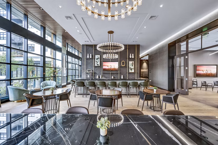 Modern clubhouse with sleek furniture at Avenu at Natick Apartments, perfect for social gatherings and relaxation