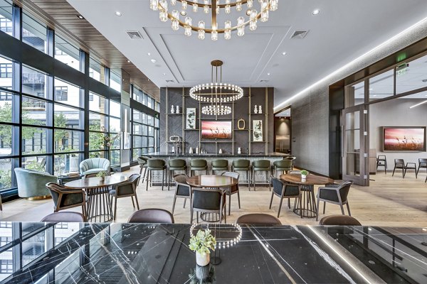 Modern clubhouse with sleek furniture at Avenu at Natick Apartments, perfect for social gatherings and relaxation