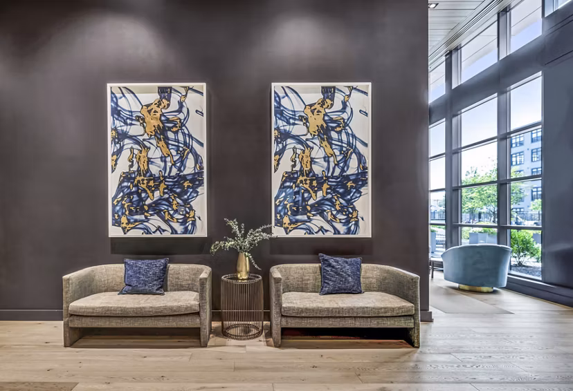 Elegant clubhouse with modern furnishings at Avenu at Natick Apartments, offering luxury amenities and gathering spaces