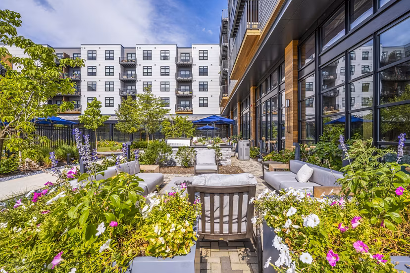 Spacious patio with garden view at Avenu at Natick Apartments