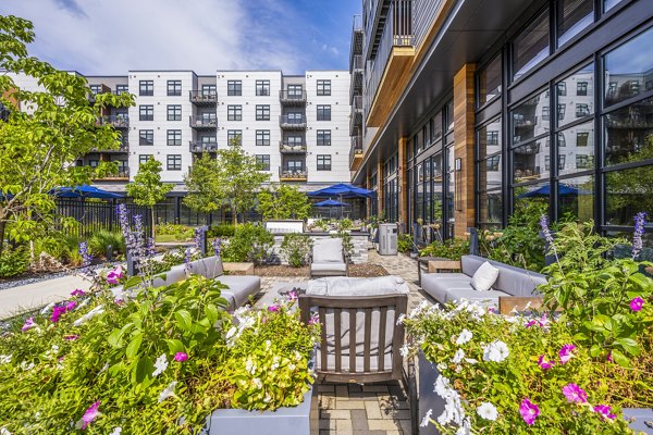 Spacious patio with garden view at Avenu at Natick Apartments