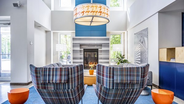 Clubhouse lobby featuring modern dÃ©cor and comfortable seating at One North of Boston Apartments