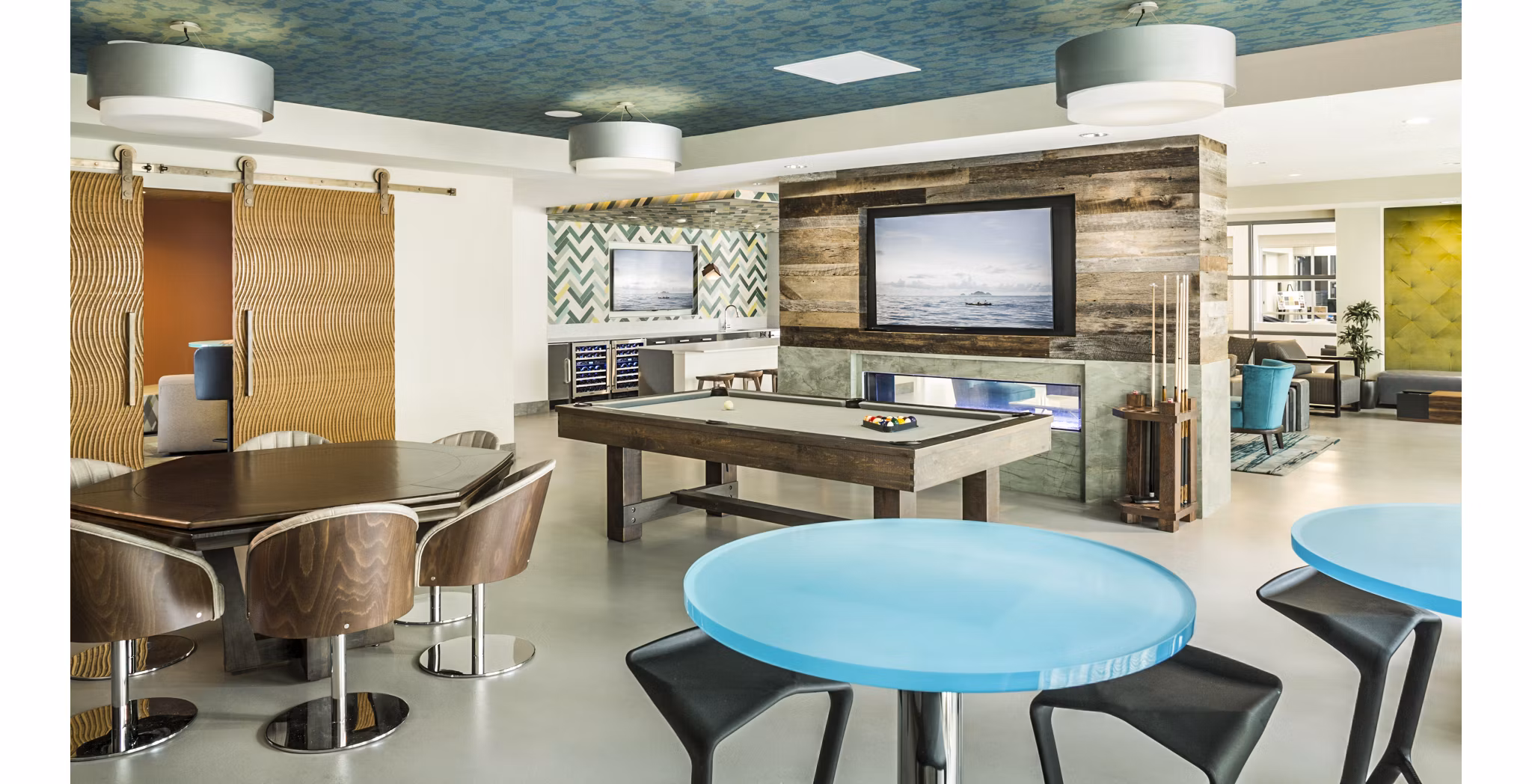 Clubhouse game room with pool table and lounge seating at One North of Boston Apartments luxury community