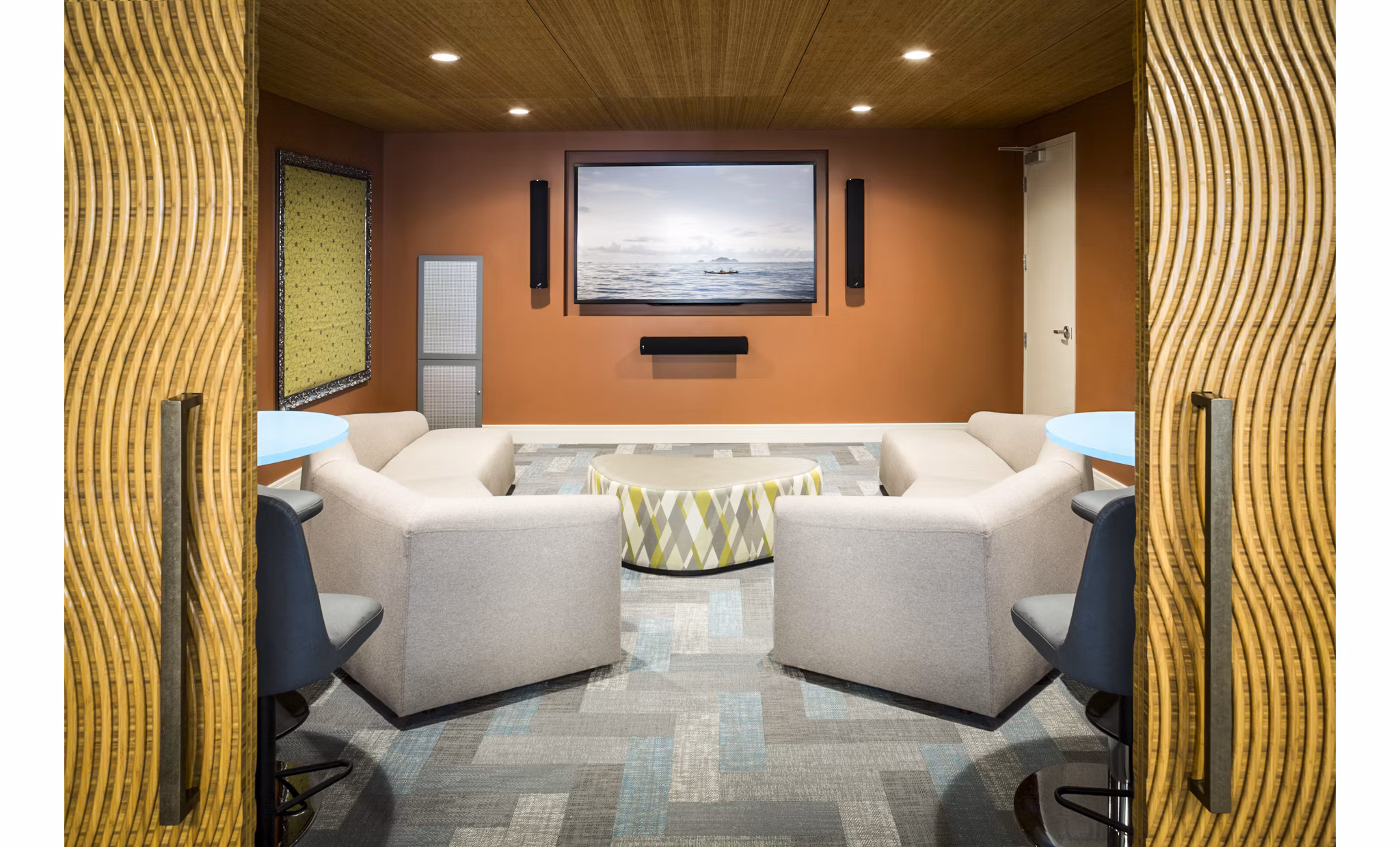 Cozy clubhouse theater with plush seating at One North of Boston Apartments, enhancing entertainment options for residents