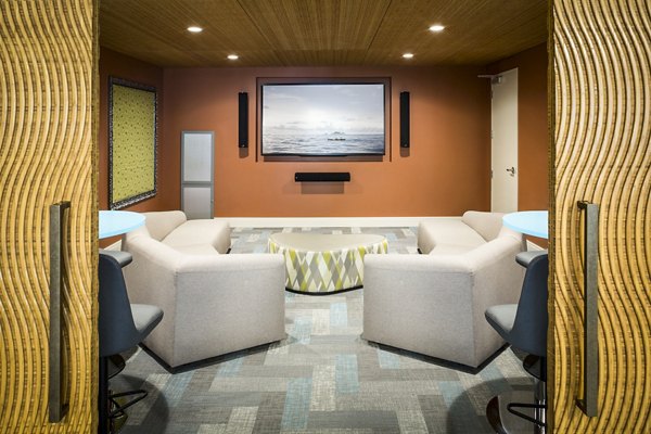 Cozy clubhouse theater with plush seating at One North of Boston Apartments, enhancing entertainment options for residents