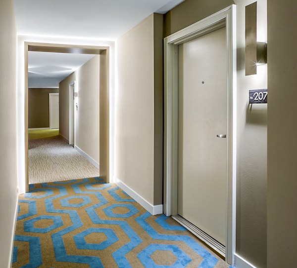 Bright hallway with modern lighting and art in One North of Boston Apartments