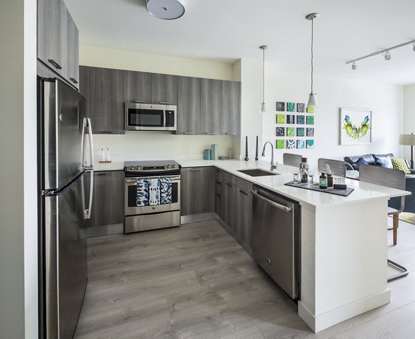 Modern kitchen with stainless steel appliances at One North of Boston Apartments