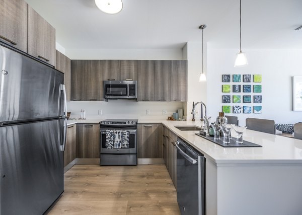 Modern kitchen featuring stainless steel appliances and sleek cabinetry in One North of Boston Apartments