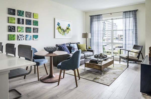 Spacious living room with modern furnishings in One North of Boston Apartments