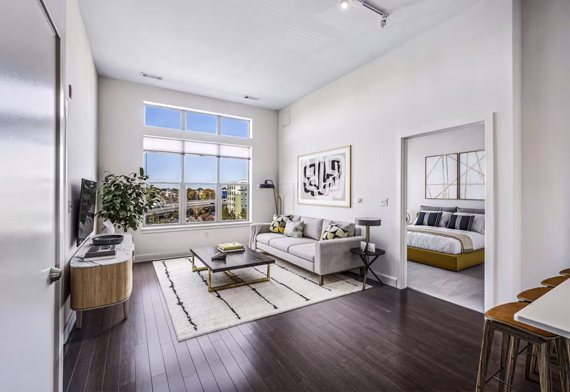 Modern living room with plush seating and large windows at One North of Boston Apartments
