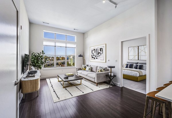 Modern living room with plush seating and large windows at One North of Boston Apartments