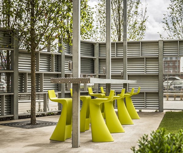 Patio with seating and outdoor lighting at One North of Boston Apartments