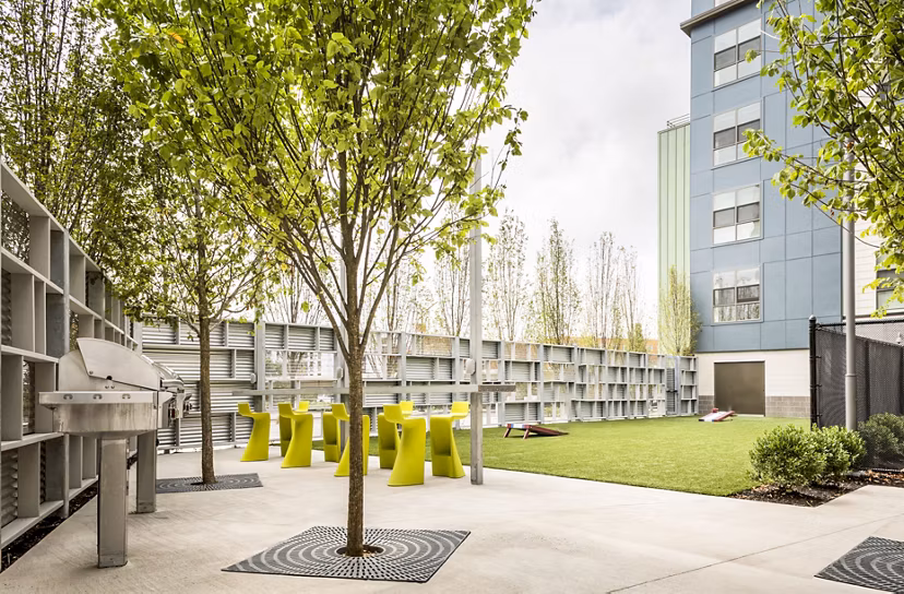 Outdoor grill area with modern seating at One North of Boston Apartments, perfect for hosting gatherings and enjoying fresh air cooking experiences