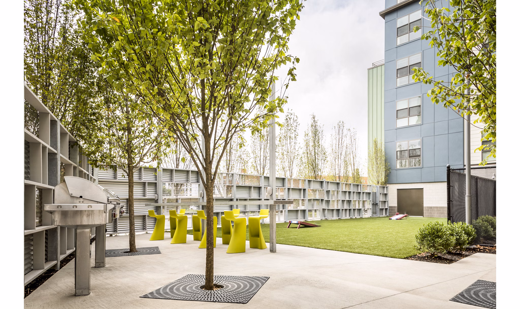 Outdoor grill area with modern seating at One North of Boston Apartments, perfect for hosting gatherings and enjoying fresh air cooking experiences