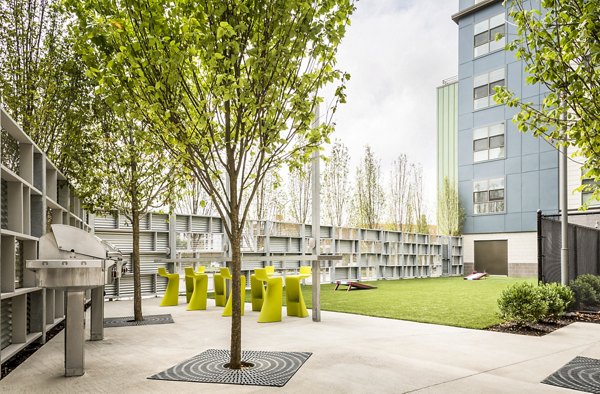 Outdoor grill area with modern seating at One North of Boston Apartments, perfect for hosting gatherings and enjoying fresh air cooking experiences