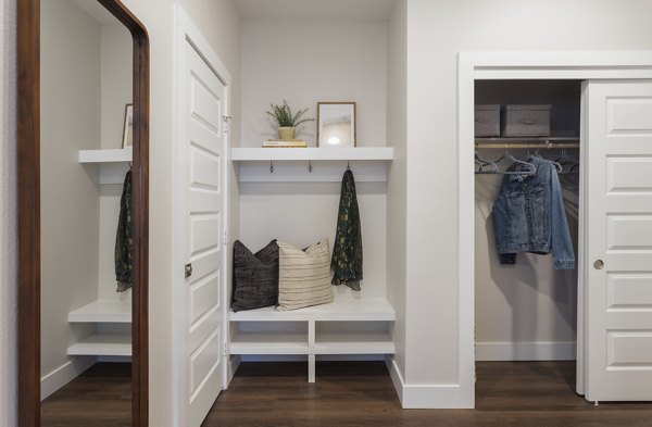 Hallway with modern lighting and art installations at Broadstone Wren Apartments
