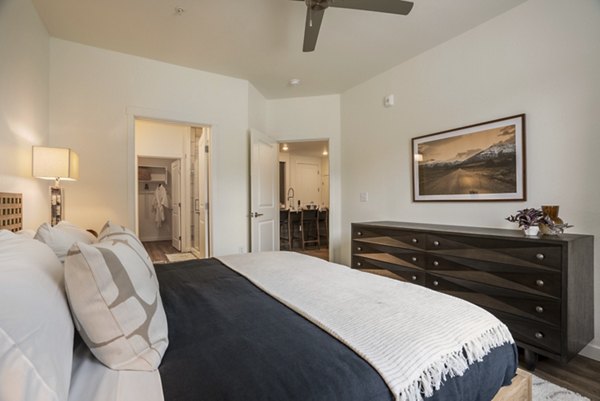 Elegant bedroom with modern furnishings at Allaso Journal Center Apartments