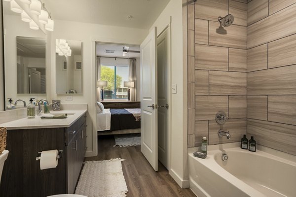 Luxurious bathroom featuring marble countertops and modern fixtures at Allaso Journal Center Apartments