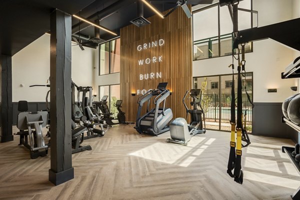 Modern fitness center with state-of-the-art equipment at Allaso Journal Center Apartments for a luxurious workout experience