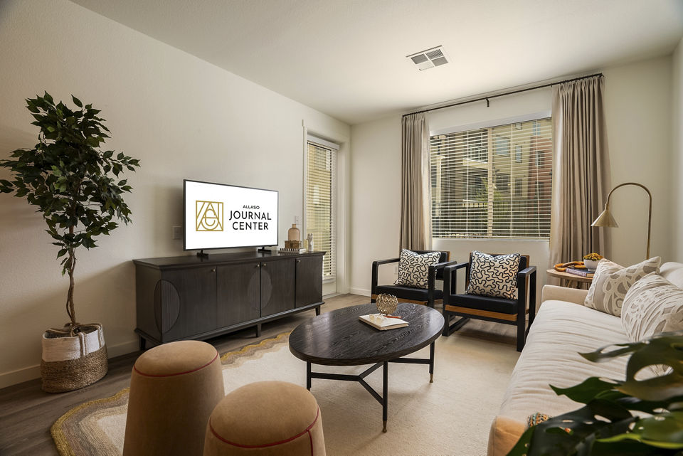 Spacious living room with modern decor in Allaso Journal Center Apartments