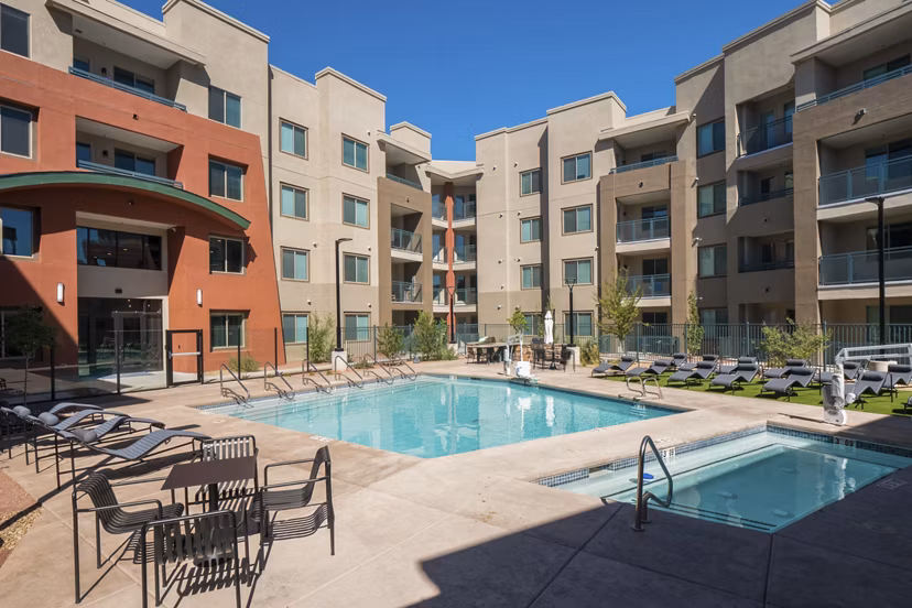 Modern pool with poolside seating at Allaso Journal Center Apartments offering luxury leisure experiences
