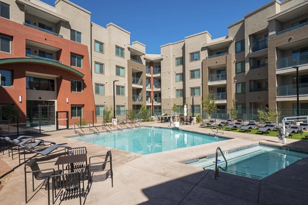 Modern pool with poolside seating at Allaso Journal Center Apartments offering luxury leisure experiences