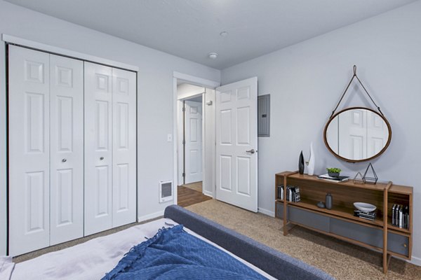 Cozy bedroom with modern decor and ample natural light at Trillium Apartments