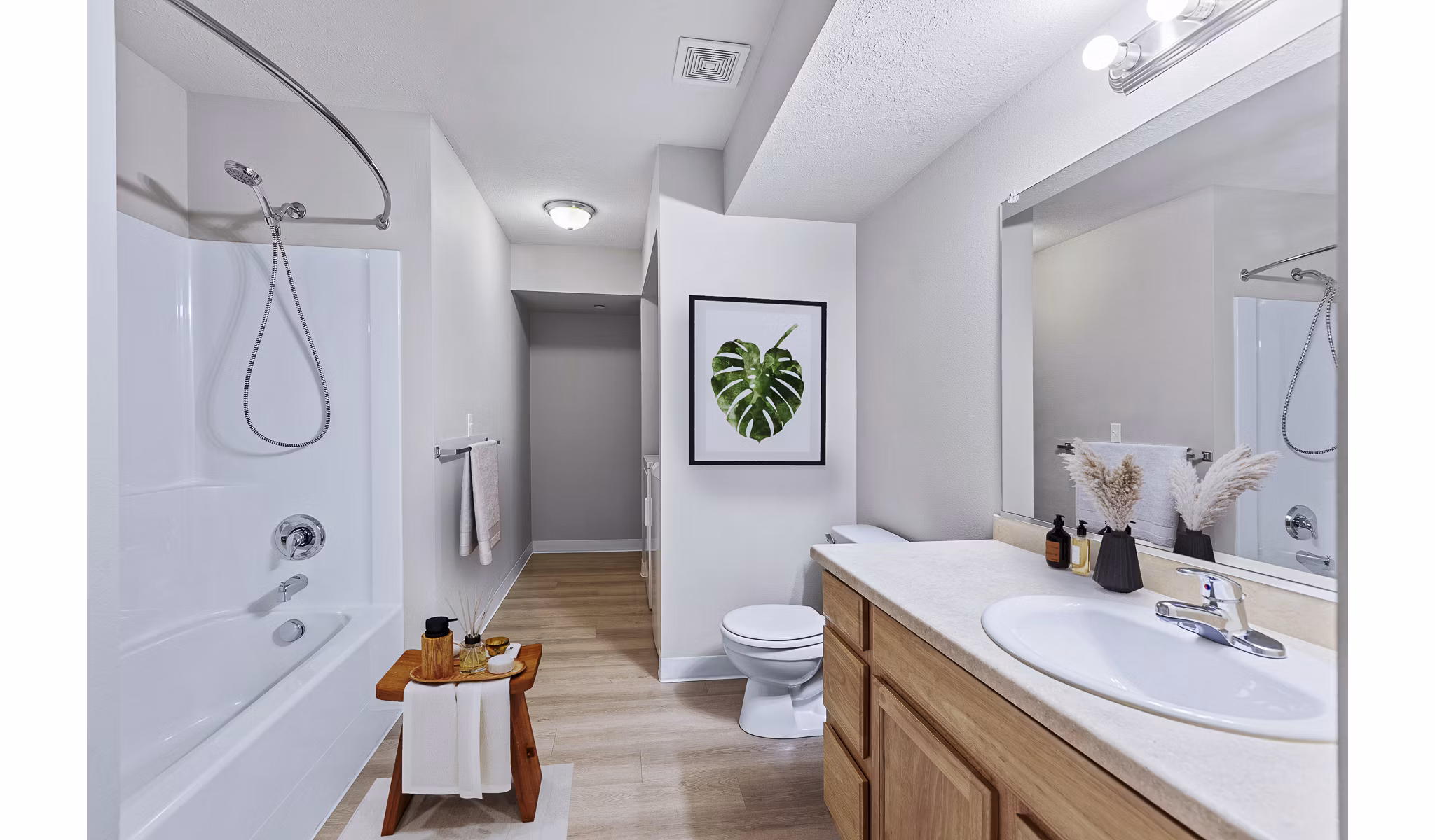Modern bathroom with sleek fixtures and ample lighting at Trillium Apartments