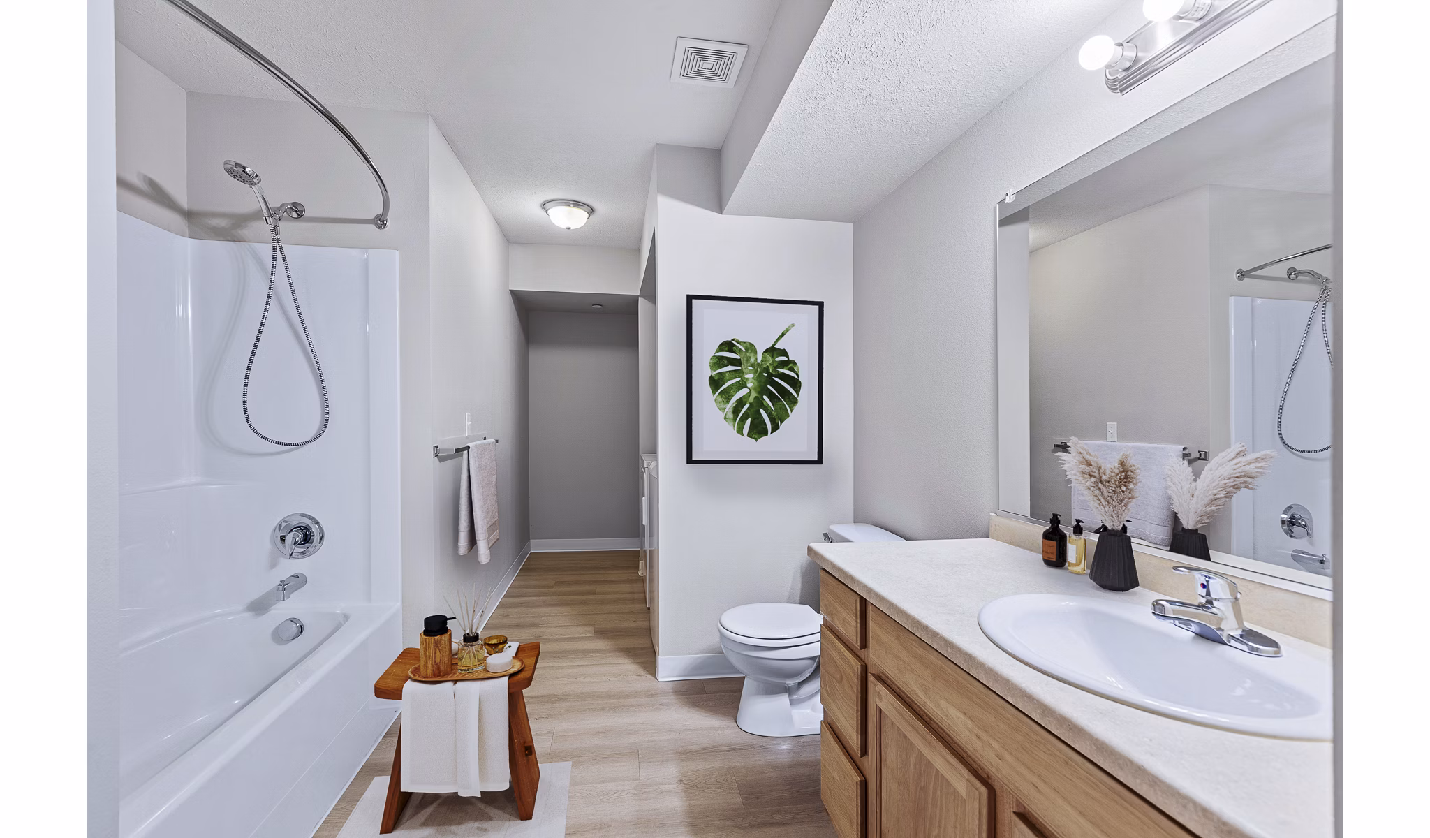 Modern bathroom with sleek fixtures and ample lighting at Trillium Apartments