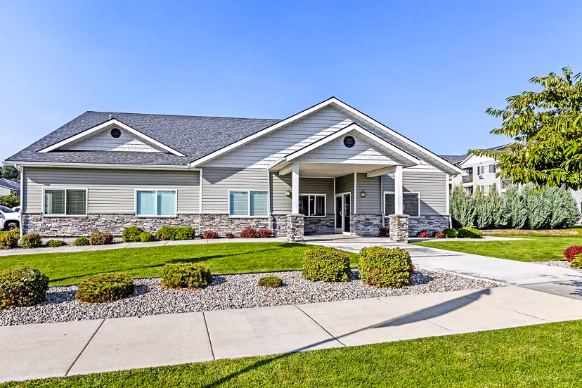 Trillium Apartments: Elegant entrance with lush landscaping in downtown setting